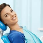woman smiles in dental chair